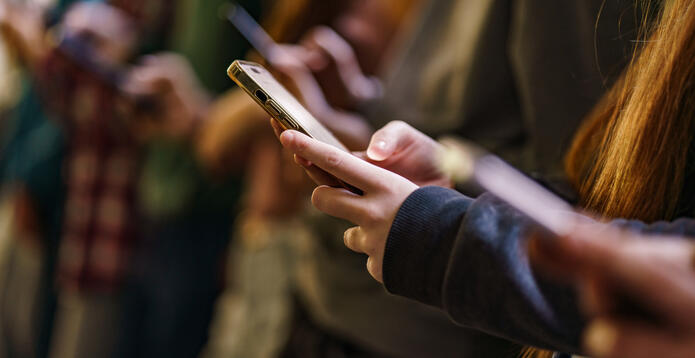 Close-up of mobile phones in hands of children_Digital - Website - Standard ImageCard