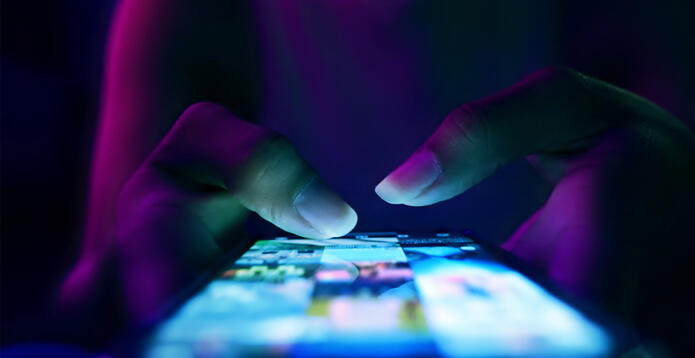 Fingers of a woman using a smartphone