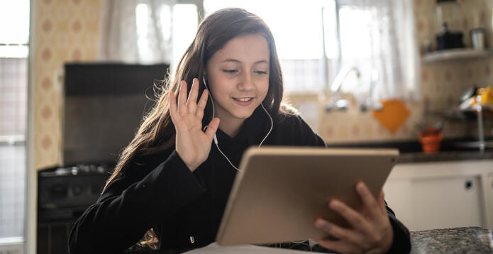 Girl on tablet with earphones in waving_Digital - Website - Standard ImageCard