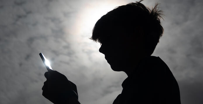 Silhouette of boy on phone_Digital - Website - Standard ImageCard