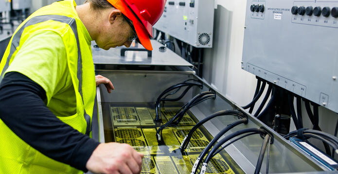 Technician Inspecting Server in Immersion Cooling Tank stock photo