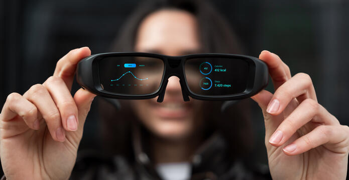 Woman holding smart glasses