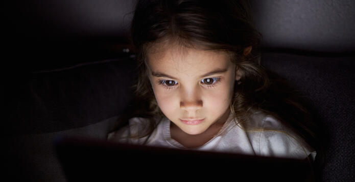 Young girl face glowing using tablet_Digital - Website - Standard ImageCard