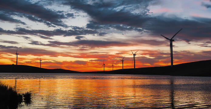 Windmills on a lake at sunset in Ireland