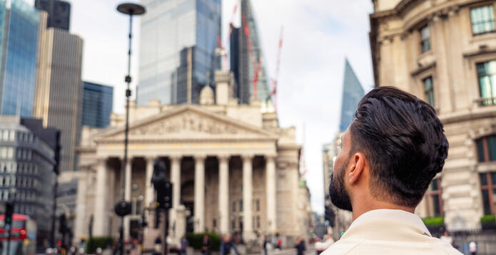 Person looks onto Bank of England building and the City