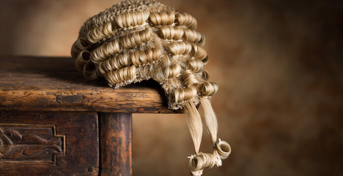 Barrister wig drooping from edge of table