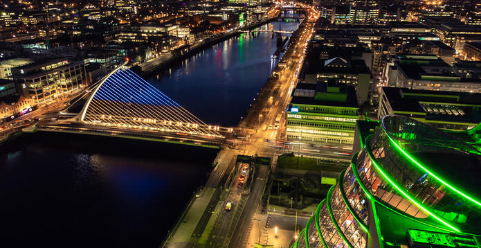 Dublin city at night with lights on and the sunset