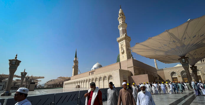 Pilgrims walking outside Al-Masjid an-Nabawi in Medina, Saudi Arabia