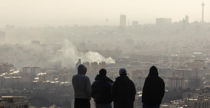 Men look over Tehran explosion_Digital - Website - Standard ImageCard