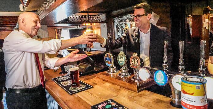 Prime minister Andy Burnham and chancellor John Healy celebrate slashing business rates