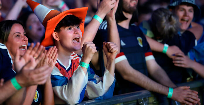 Scotland fans celebrating while watching the national team