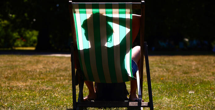 A person sleeps in a deckchair in St James's Park during the UK heatwave. Photo: Alishia Abodunde/Getty Images