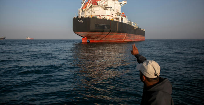 A ship remains anchored in the Strait of Hormuz near Larak Island, Iran
