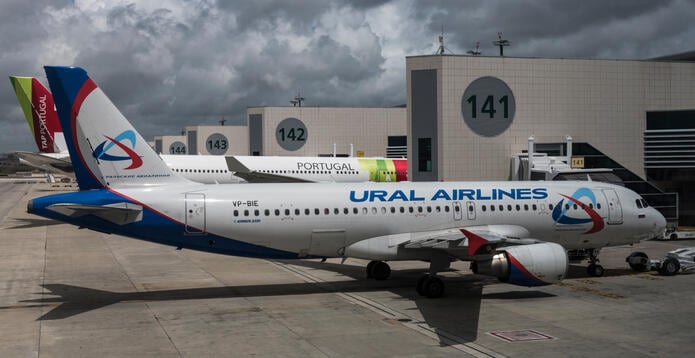 A Russian Ural Airlines A320 in front of a Portugese flag carrier TAP's airplane at Lisbon Humberto Delgado Airport. 