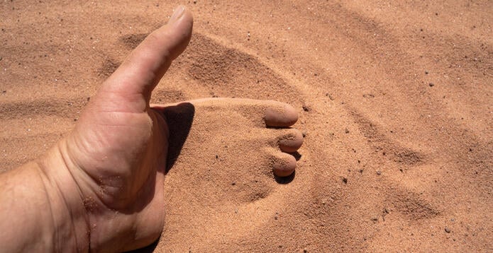 Hand in sand