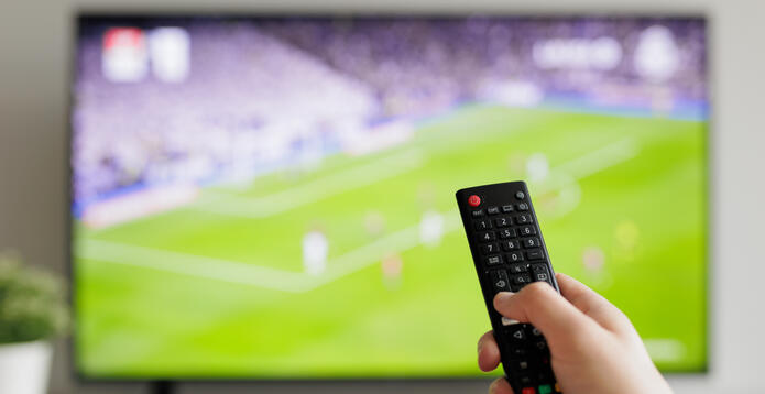 Smart TV showing football plus remote