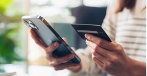 woman-hand-holding-credit-cards-and-using-smartphone-for-shopping-online-with-payment-on card