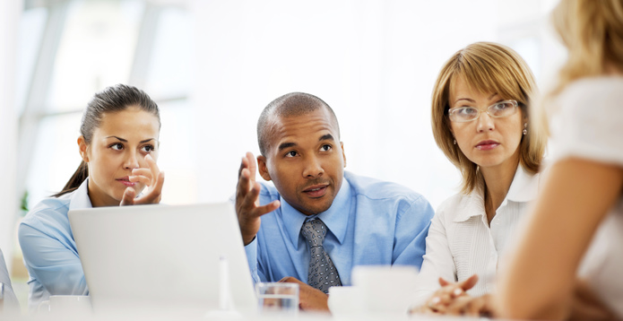 Smiling group of businesspeople working at laptop-695