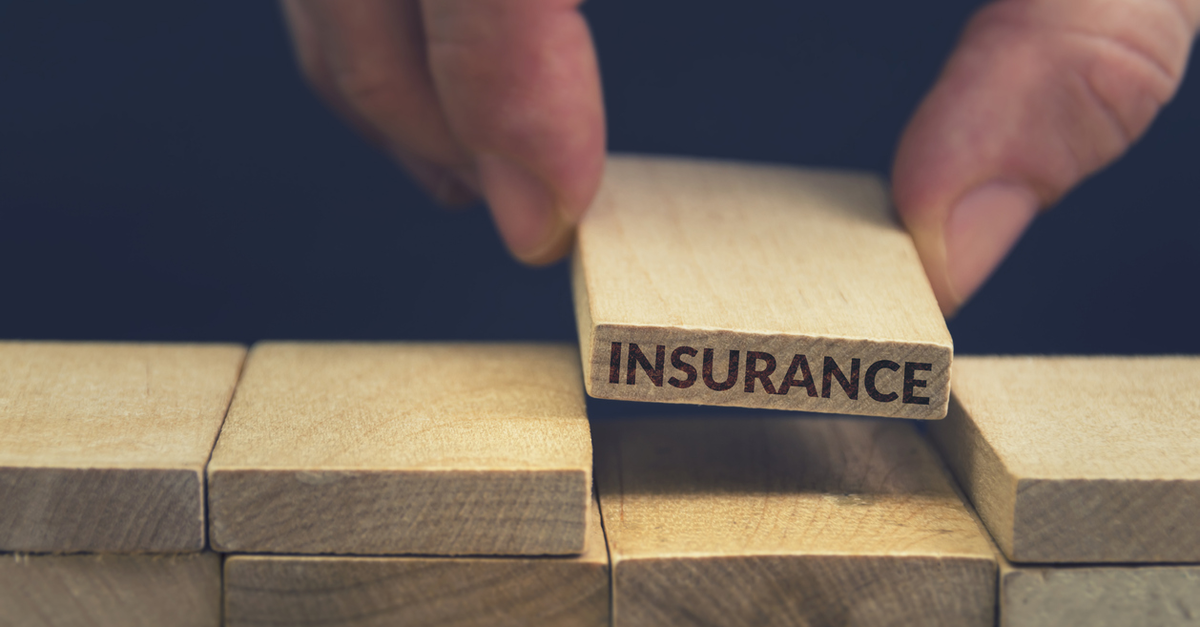 Wooden block with word insurance on it