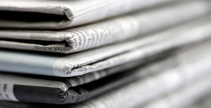 Newspapers folded and stacked Card