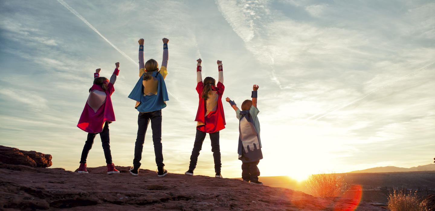 Children in superhero capes