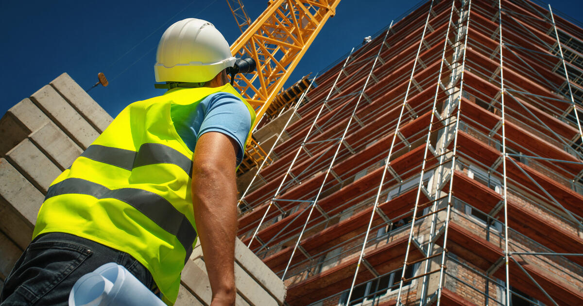Closeup of a construction engineer standing in front of a building