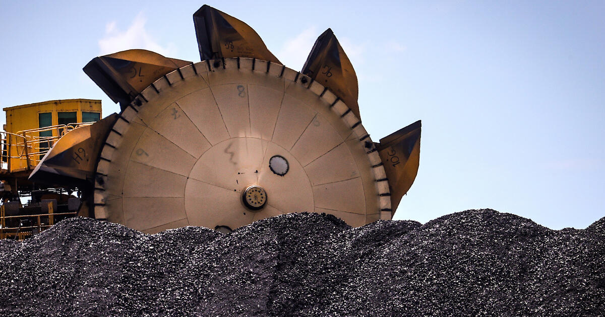 Pile of coal and excavator_Digital - SEOSocialEditorial image