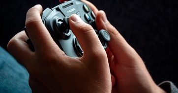 A person using a gaming controller. Matt Cardy/Getty Images.