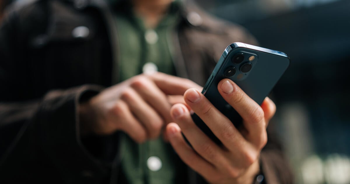 Man on street mobile browsing_Digital - SEOSocialEditorial image