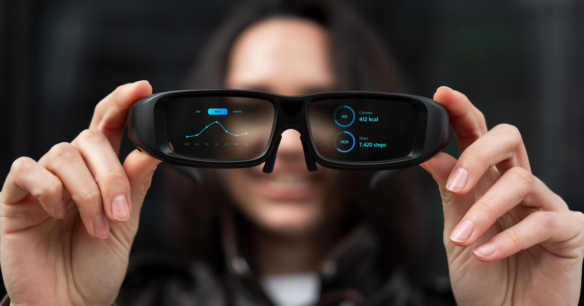 Woman holding smart glasses
