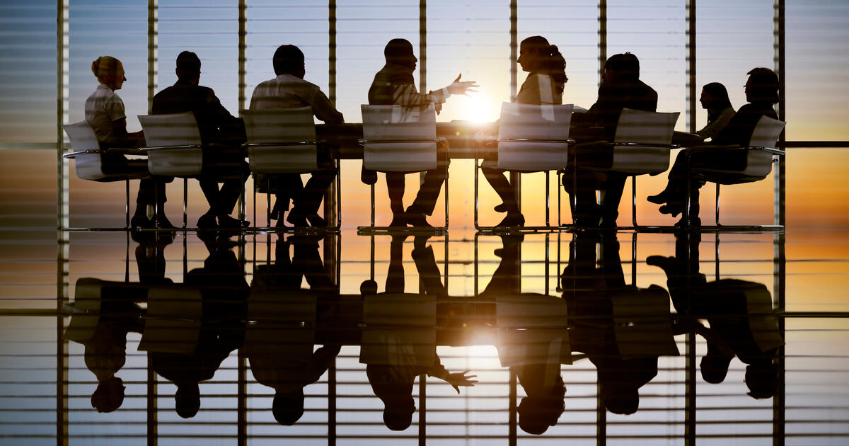 Boardroom meeting people silhouetted