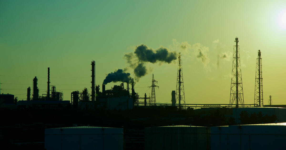 A silhouetted view of the Yongyeon Industrial Complex during sunset