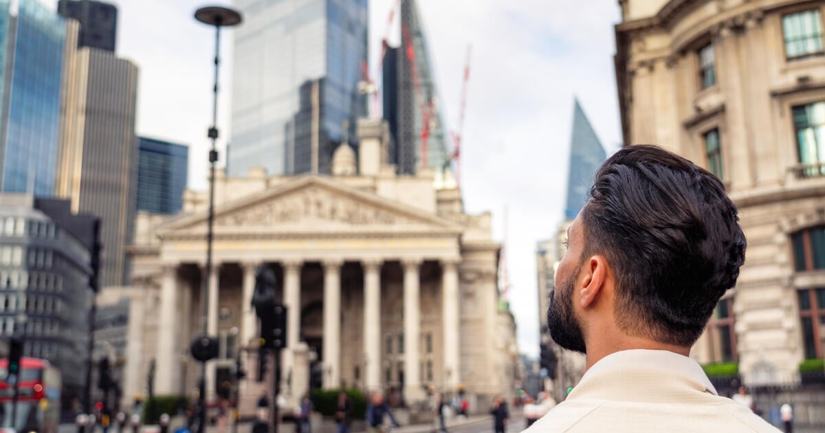 Person looks onto Bank of England building and the City