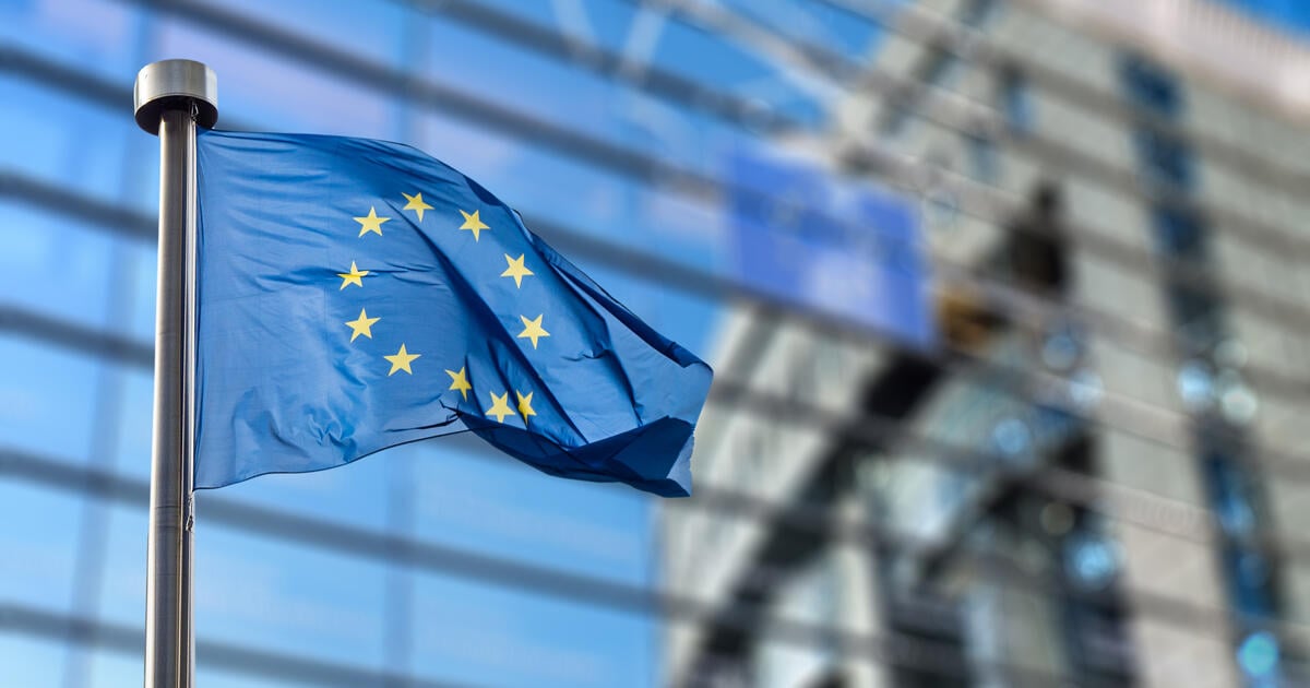 EU flag with blurred glass building background