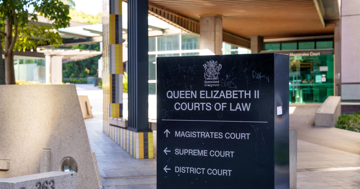 Close up of a sign with directions towards the Magistrates Court, Supreme Court and District Court in Brisbane city centre.