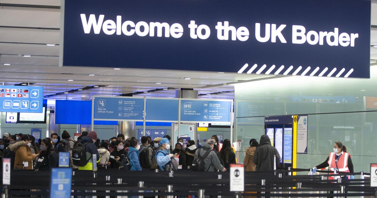 Passengers queuing at a UK Border control point
