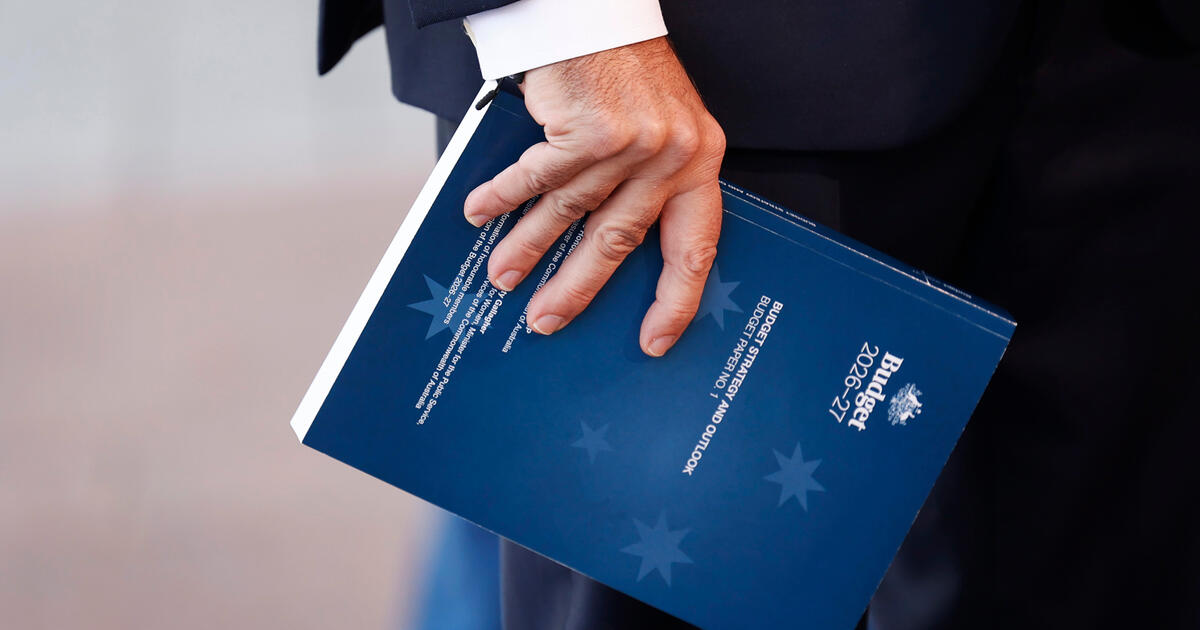 Treasurer Jim Chalmers holds a copy of the 2026 budget