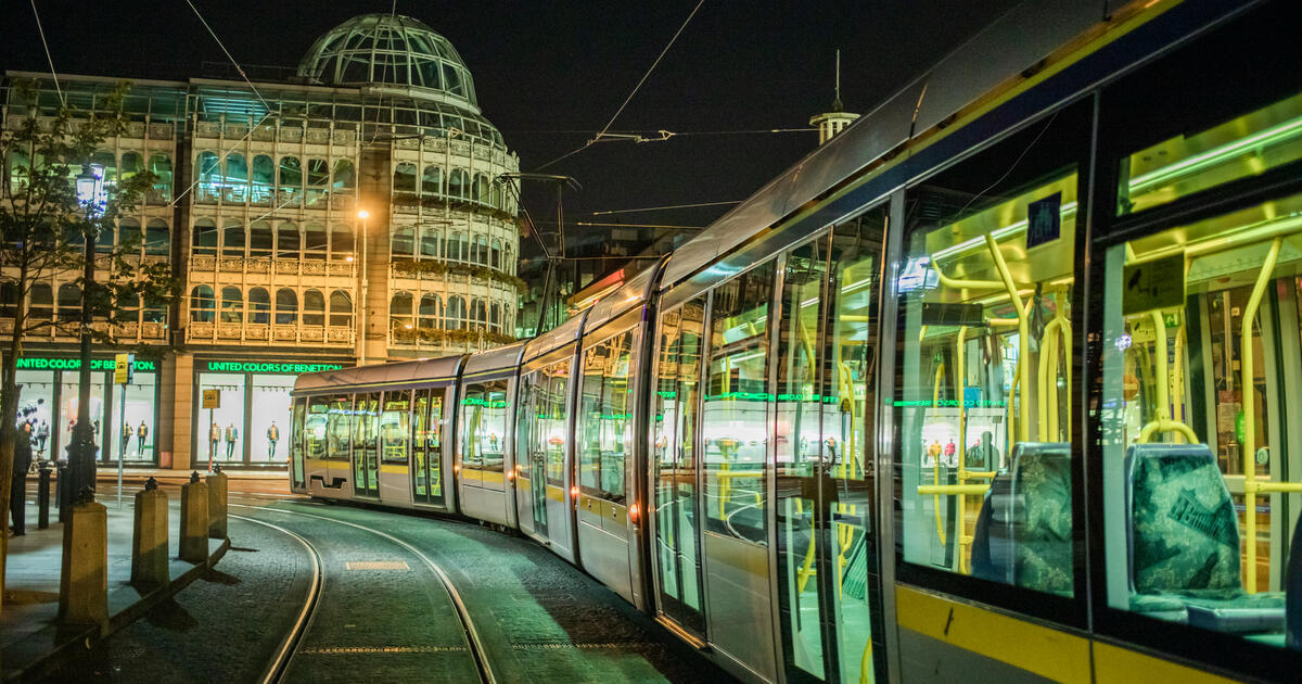 Tram on a city street at night