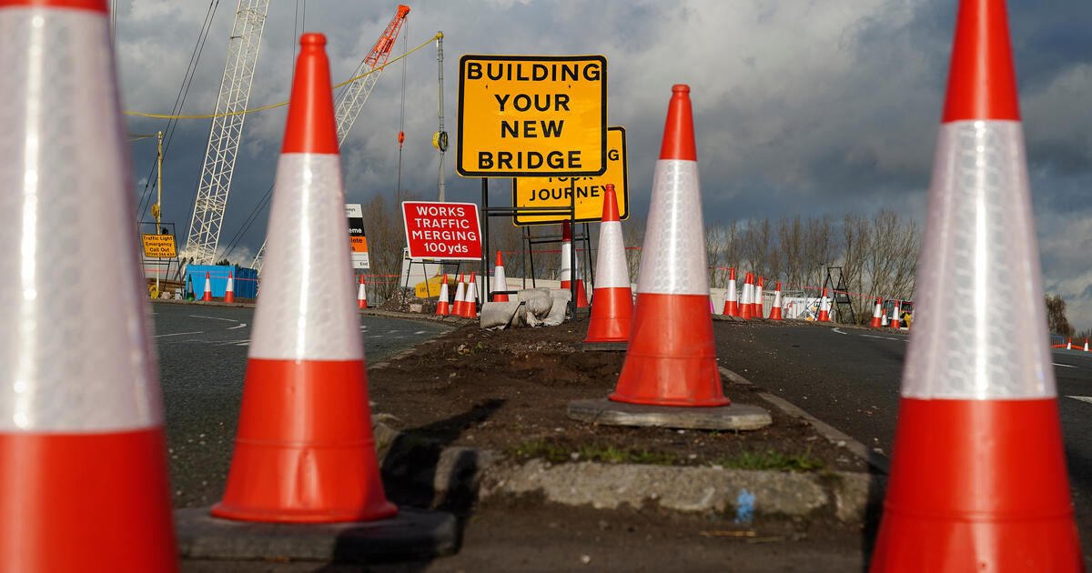 Road signs and traffic cones stand by roadworks and junction improvements at Junction 19 of the M6 motorway in Knutsford, England