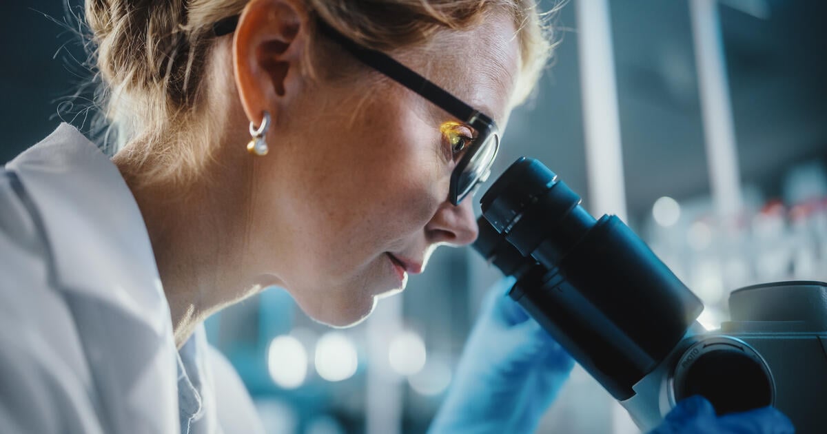 Microbiologist using equipment