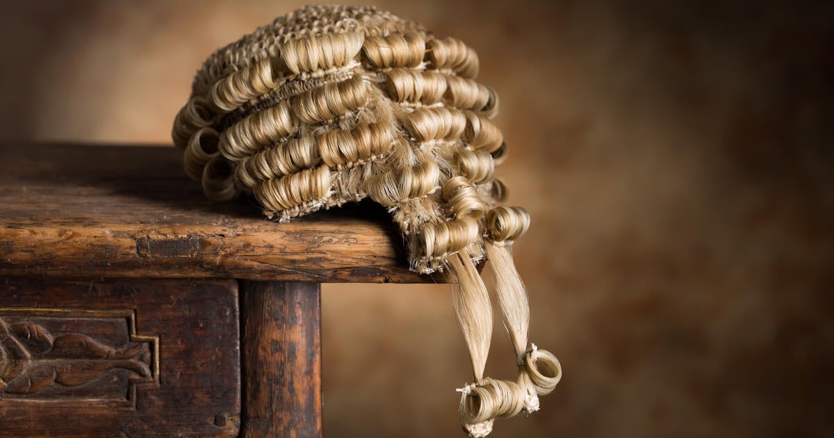 Barrister wig drooping from edge of table