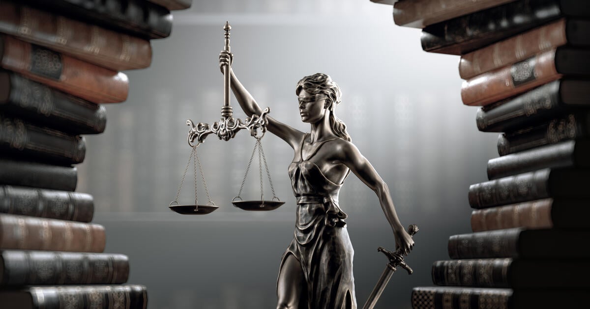 Books surround Themis statute of justice_Digital - SEOSocialEditorial image