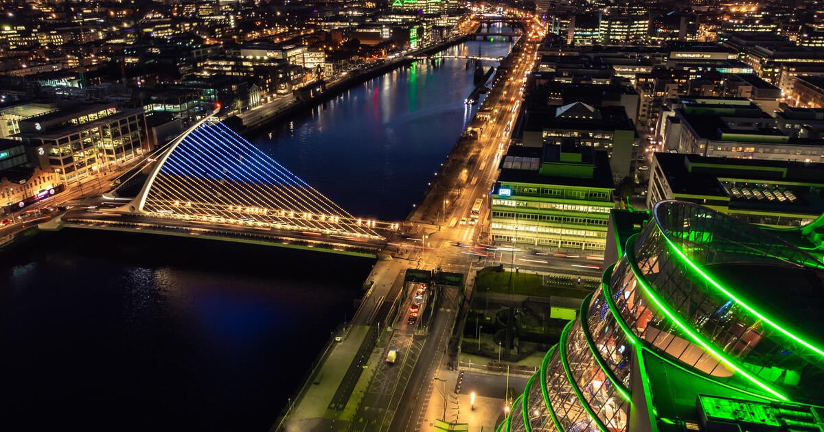 Dublin city at night with lights on and the sunset