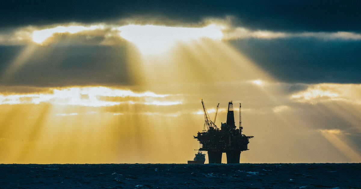 Offshore oil platform illuminated by sun rays