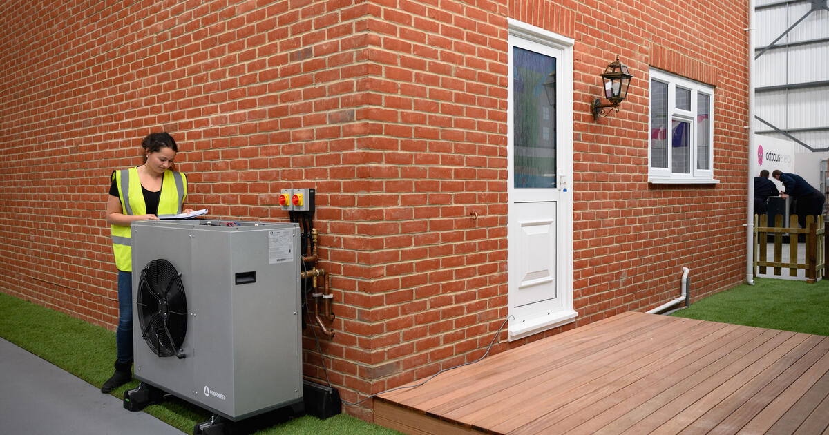Heat pump outside red brick home_Digital - SEOSocialEditorial image