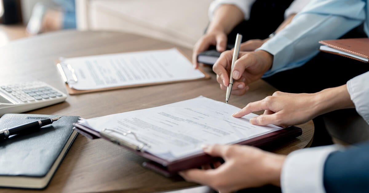 Real Estate Agent explain insurance and sign contract agreement contract to client