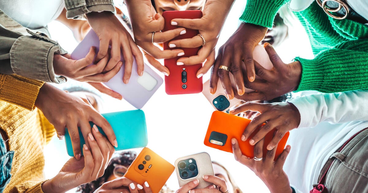 Circle of hands using colourful mobiles