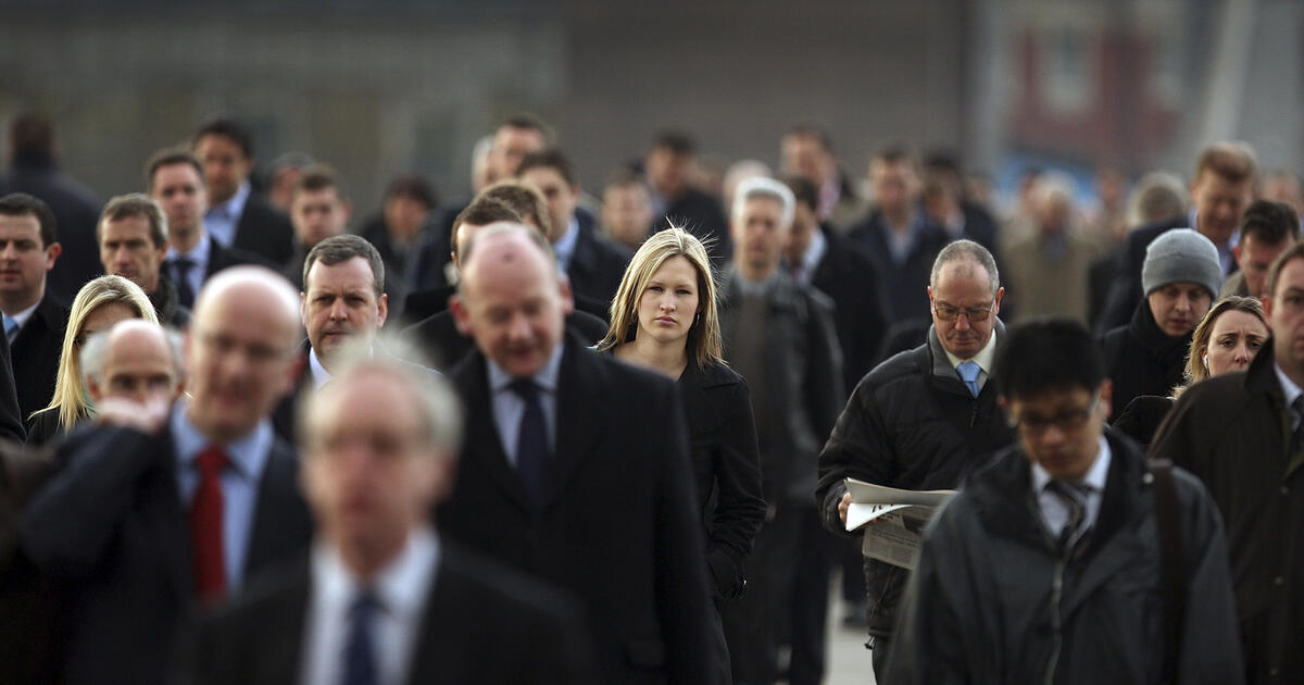 Commuters walk to work in the city of London