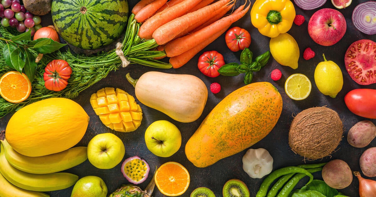 Colorful raw fruits and vegetables varied vegan food - SEOSocialEditorial image