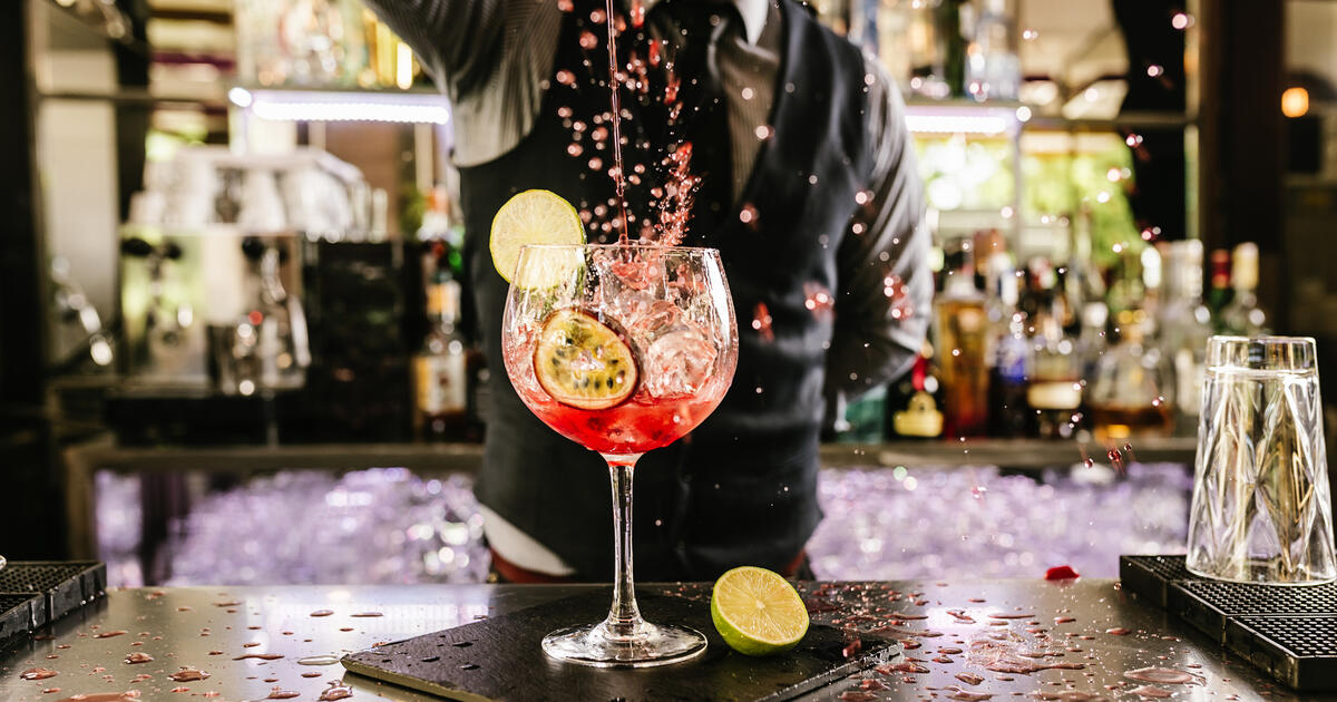 Drink being poured by barman